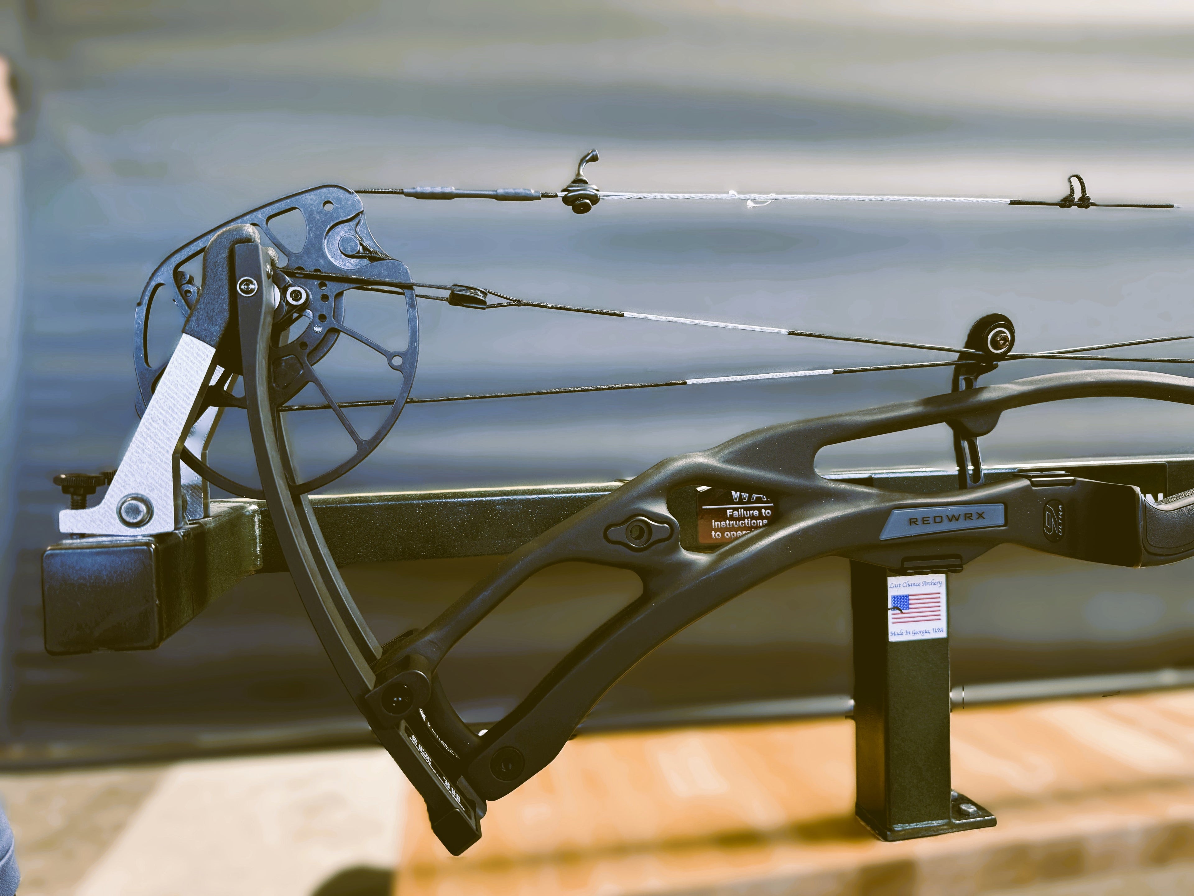 compound bow on a wooden workbench